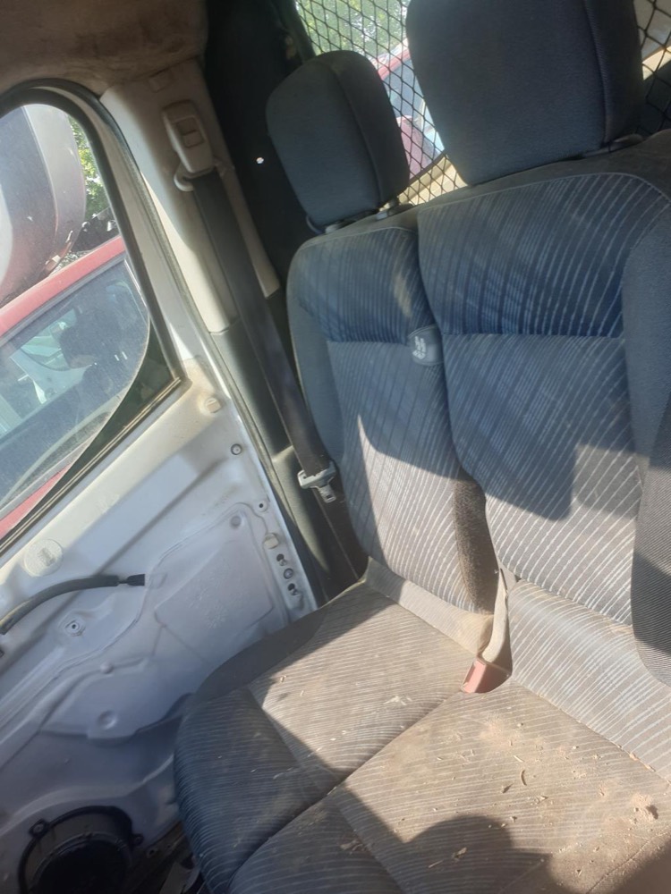 Banquette de Peugeot Partner encore montée dans le véhicule, poussiéreuse, en plein soleil